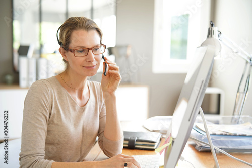 young business woman on the phone in an office