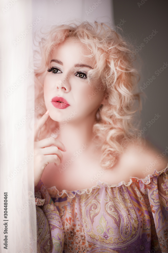 beautiful young woman looking out the window beautiful young woman looking out the window