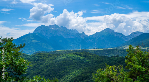 Panorama of beautiful countryside of France. Sunny day. Wonderful springtime landscape in mountains. Grassy field and rolling hills. Rural scenery. Amazing view French Alps.