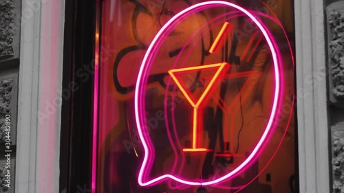 neon cocktail sign on the bar nightclub window. illuminated design drink