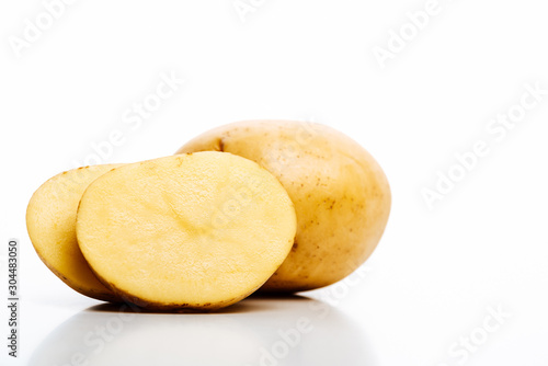 raw whole and cut fresh potatoes isolated on white