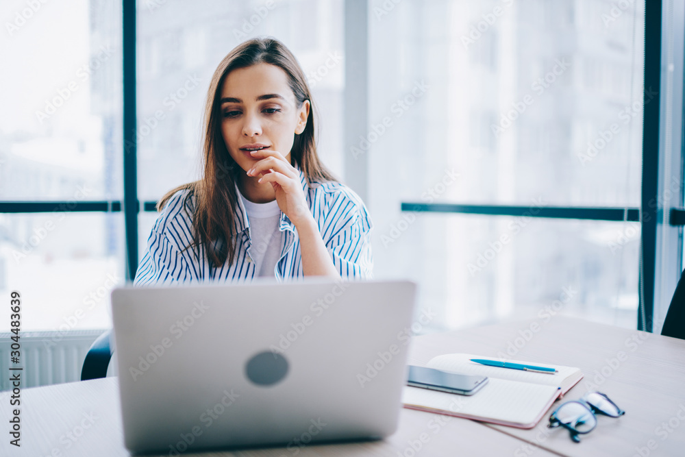 © BullRun - Pensive female woman watching video online on netbook during working process for publicating review,contemplative woman blogger checking new feed in networks browsed on laptop computer in office © BullRun - Pensive female woman watching video online on netbook during working process for publicating review,contemplative woman blogger checking new feed in networks browsed on laptop computer in office