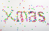 the abbreviated word Christmas is written in colored sequins of various shapes on a white background