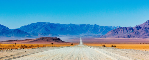 Acrylglasbilder Blau Gravel road in Namibia - panorama - Africa  © Pierre vincent