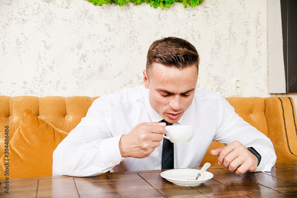 Businessman drinking a cup of coffee Businessman drinking a cup of coffee