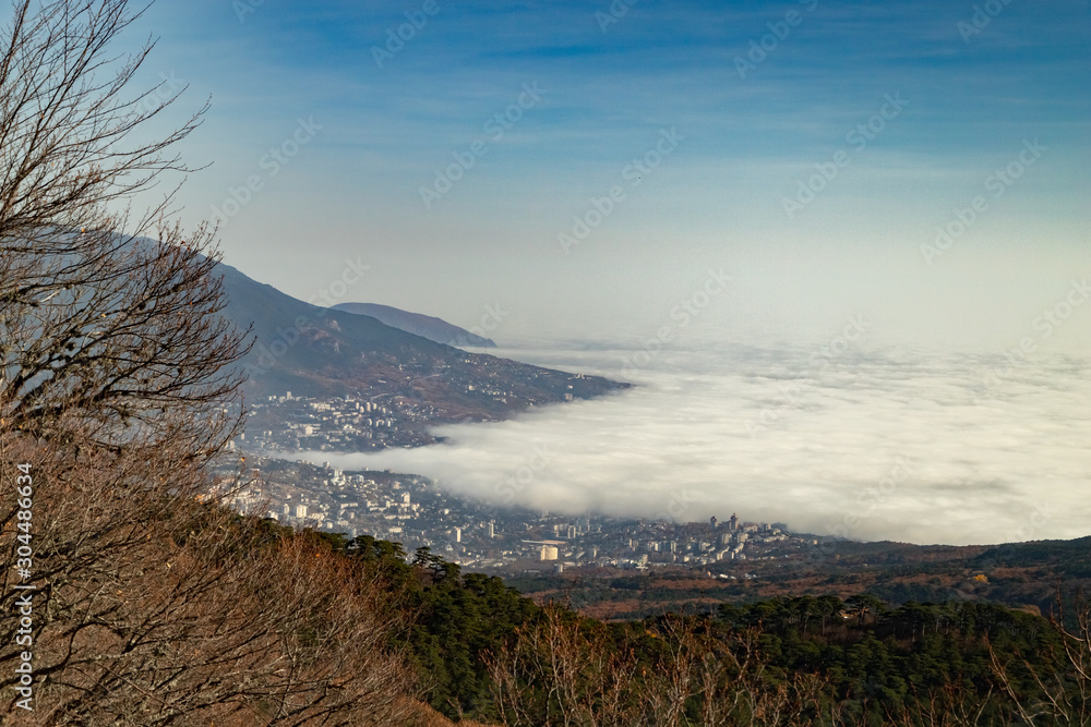 Amazing Clouds are low over the sea and creeping over the city.The view from the top.Yalta. Amazing Clouds are low over the sea and creeping over the city.The view from the top.Yalta.
