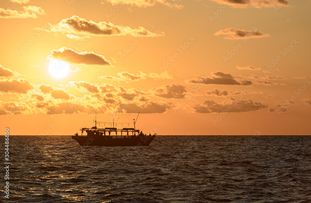 Fishing schooner at sunset