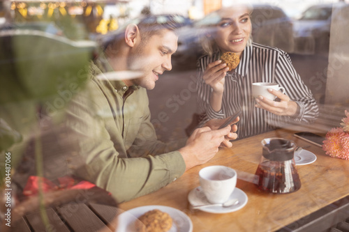 Cheerful couple having breakfast in the coffee shop