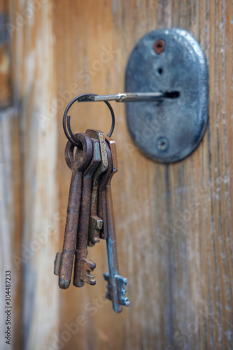 Set of old rusty keys in the keyhole
