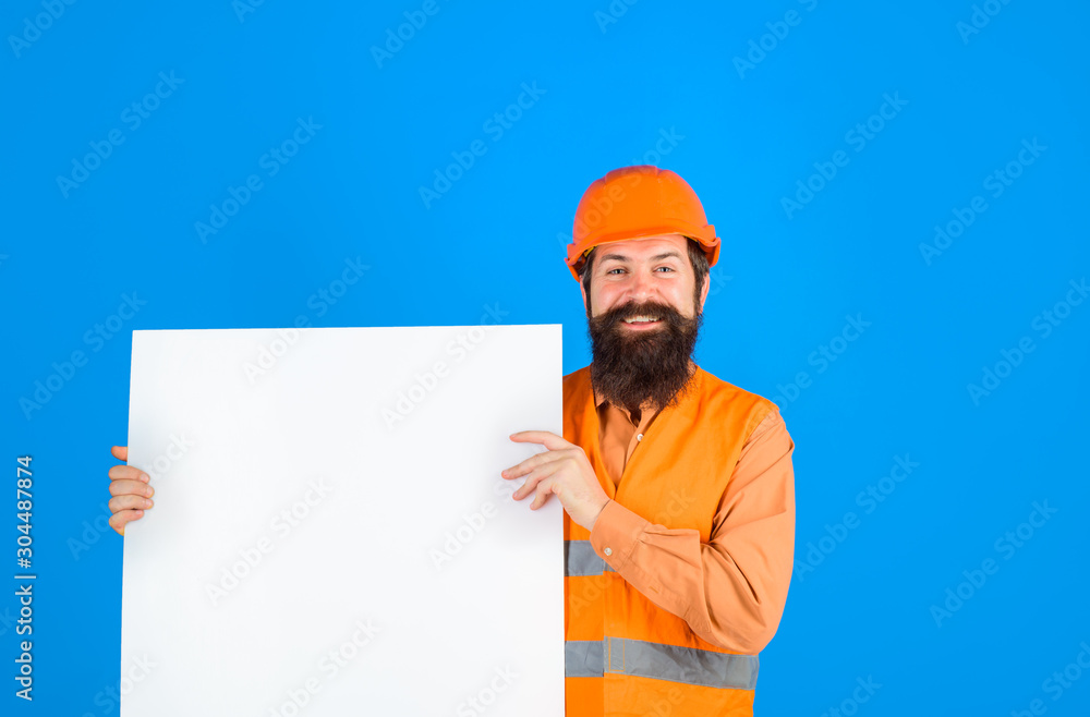 Construction worker, engineer, architect with blank board. Builder, repairman in protective helmet holds empty board with space for text. Man builder holds advertising banner, billboard, sign board. Construction worker, engineer, architect with blank board. Builder, repairman in protective helmet holds empty board with space for text. Man builder holds advertising banner, billboard, sign board.