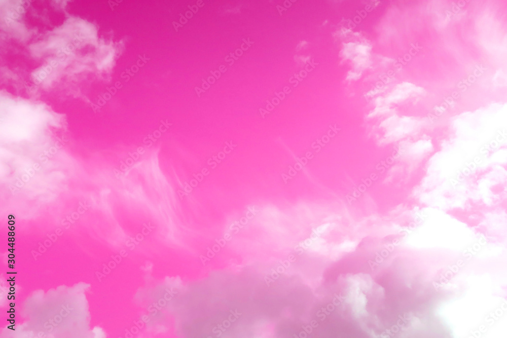 white clouds in a pink sky
