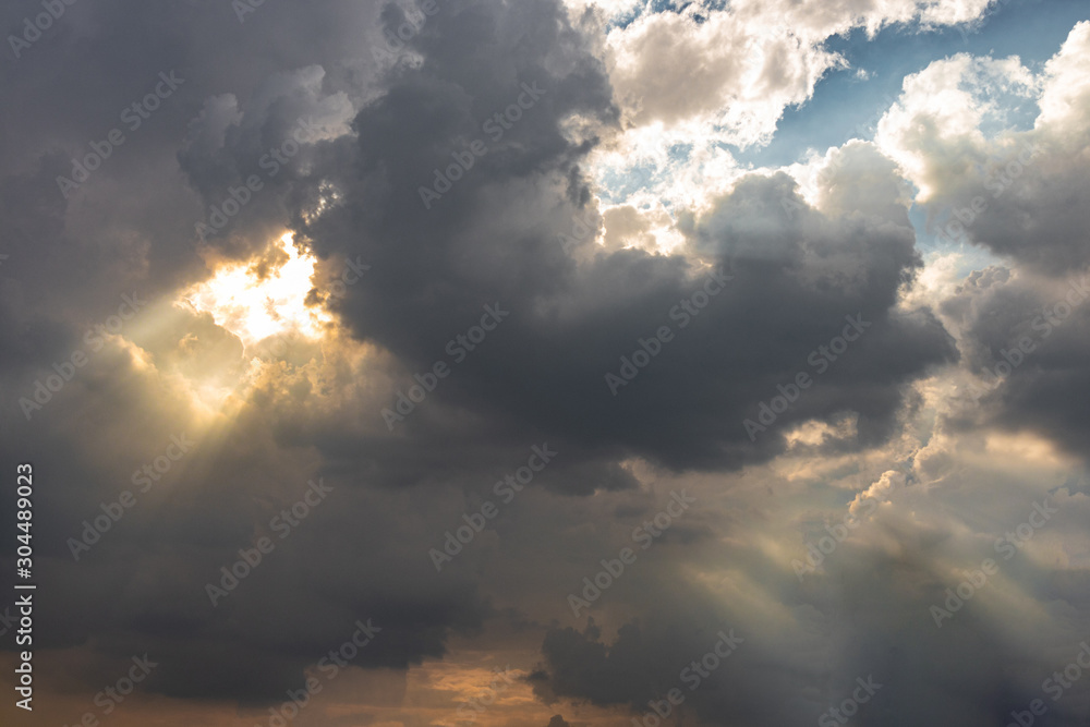 Beautiful gloden sun rays of light shining through the rain clouds in the sky, light from heaven, holy concept. Beautiful gloden sun rays of light shining through the rain clouds in the sky, light from heaven, holy concept.