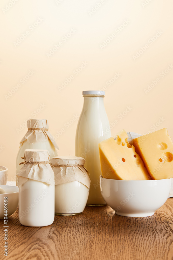 tasty organic dairy products and eggs on rustic wooden table isolated on beige tasty organic dairy products and eggs on rustic wooden table isolated on beige