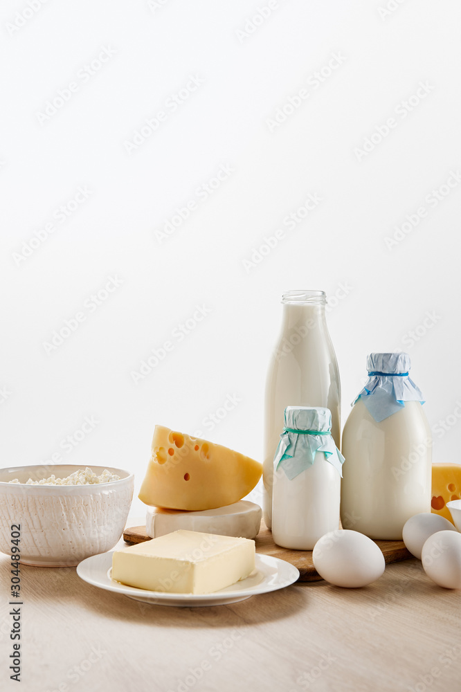 various fresh organic dairy products and eggs on wooden table isolated on white various fresh organic dairy products and eggs on wooden table isolated on white