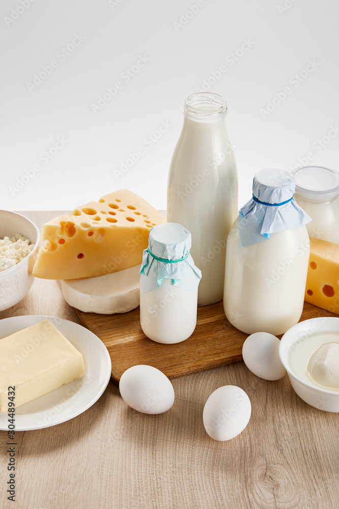 various fresh organic dairy products and eggs on wooden table isolated on white various fresh organic dairy products and eggs on wooden table isolated on white