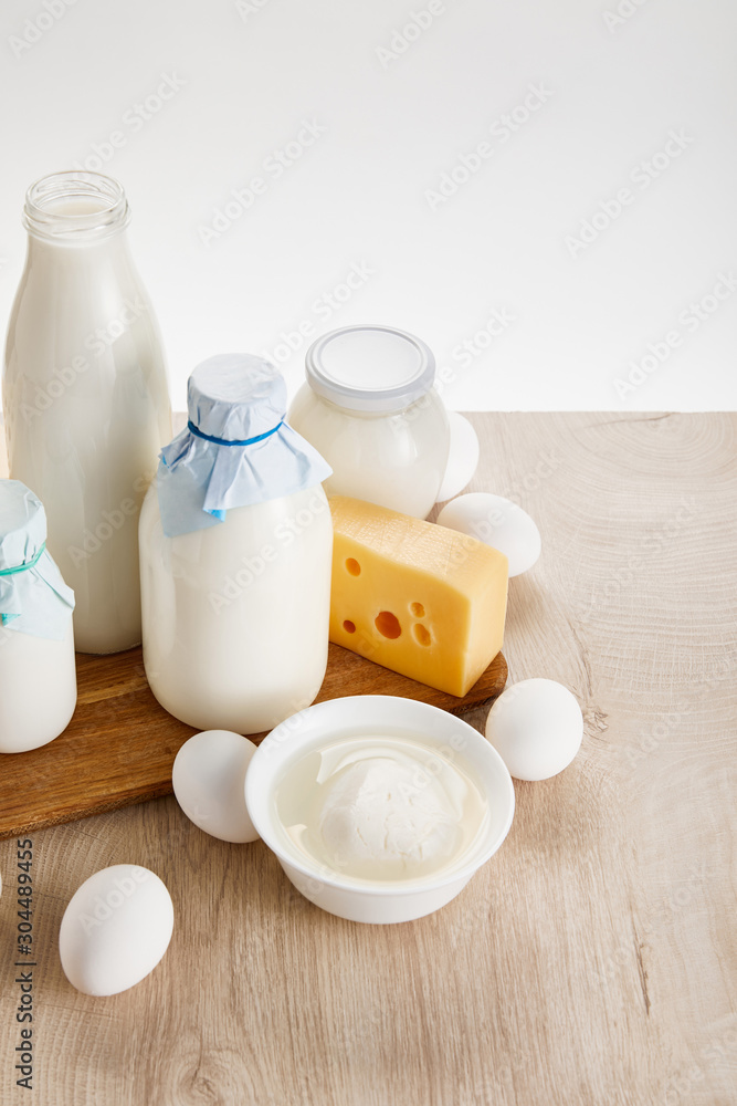 various fresh organic dairy products and eggs on wooden table isolated on white various fresh organic dairy products and eggs on wooden table isolated on white