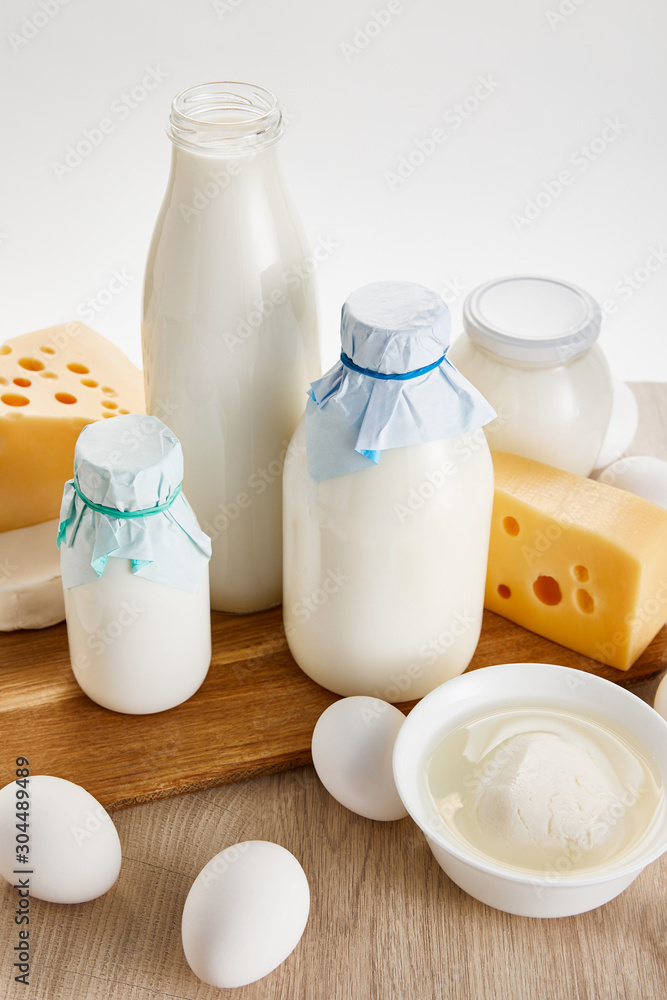 various fresh organic dairy products and eggs on wooden table isolated on white various fresh organic dairy products and eggs on wooden table isolated on white