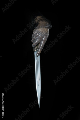 beautiful woman hands with glitter holding a sword close up