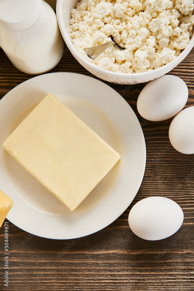 top view of delicious fresh dairy products and eggs on wooden table