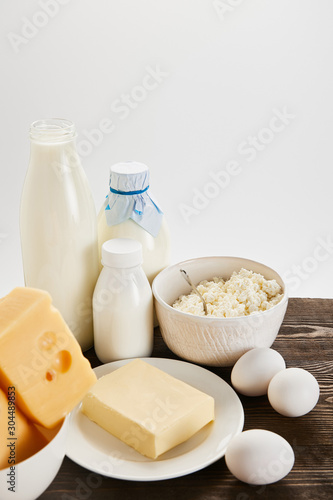 delicious fresh dairy products and eggs on wooden table isolated on white