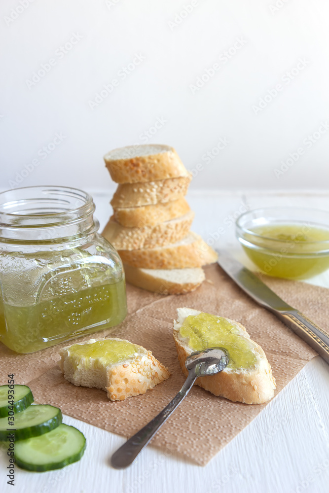 Breakfast with cucumber jam and baguette on a white background Breakfast with cucumber jam and baguette on a white background