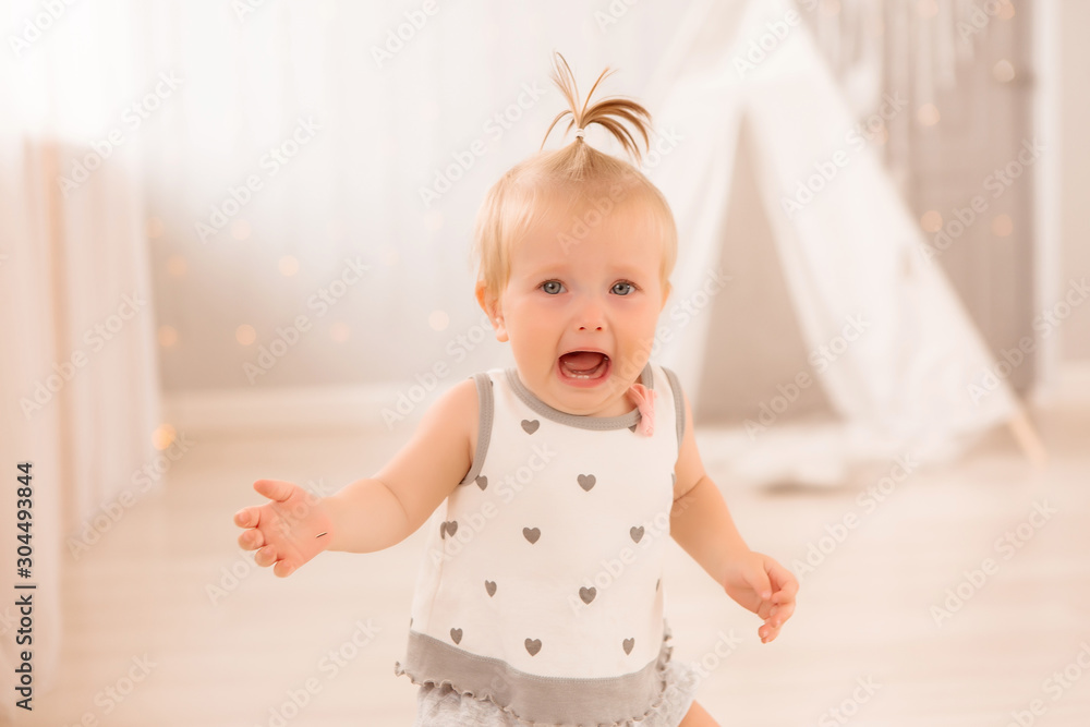 baby girl in the nursery playing,bright children's room, textiles for children's room baby girl in the nursery playing,bright children's room, textiles for children's room