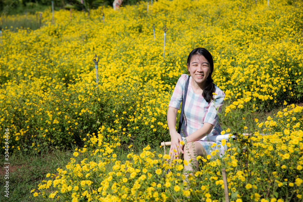 Pretty girl enjoying in a field with field flowers and smiles sincerely, Copy space Pretty girl enjoying in a field with field flowers and smiles sincerely, Copy space