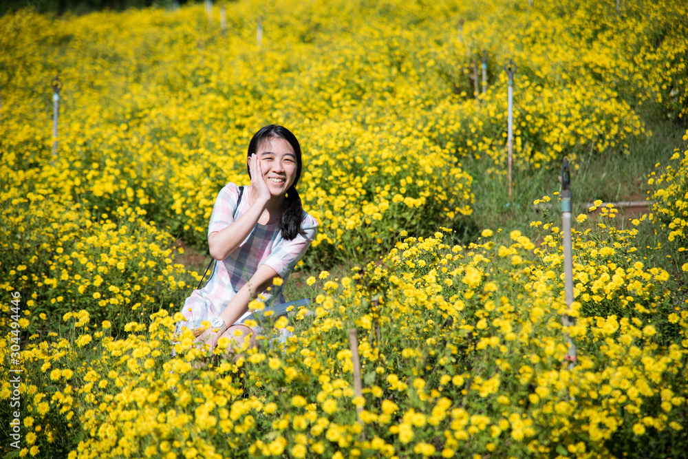 Pretty girl enjoying in a field with field flowers and smiles sincerely, Copy space Pretty girl enjoying in a field with field flowers and smiles sincerely, Copy space