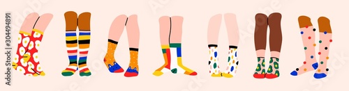 Set of seven pairs of female or male legs in the socks. Cool various prints. Stylish underwear. Fashion accessories. Footwear. Hand drawn vector colored trendy illustration. Flat design