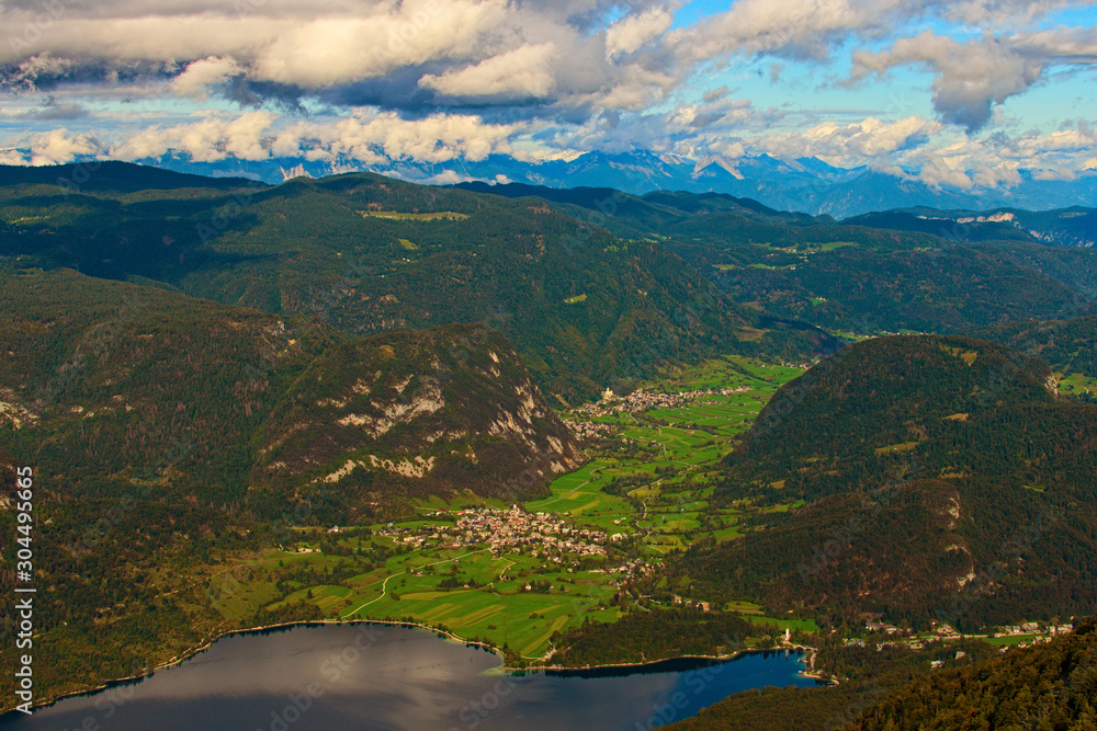 High perspective view scenic high mountains, beautiful valley with two villages and famous Bohinj Lake (Bohinjsko jezero). Famous touristic place and travel destination in Slovenia