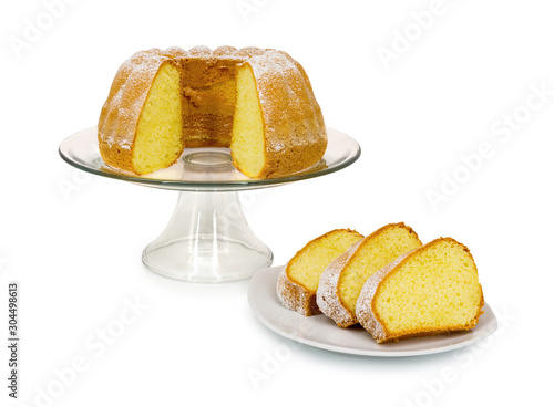 Homemade Alsatian sour cream coffee cake on glass cake plate with stand isolated on white background with shadow reflection - clipping path. Sweet bundt cake in german called Gugelhupf or Bundkuchen. photo