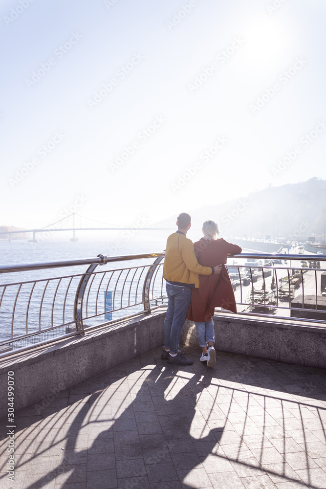 Loving couple enjoying the view from a terrace Loving couple enjoying the view from a terrace