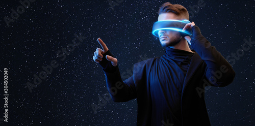 Young man in hoodie over dark virtual reality background. Guy using VR helmet. Augmented reality, future technology, game concept. Blue neon light. Black minimalism.