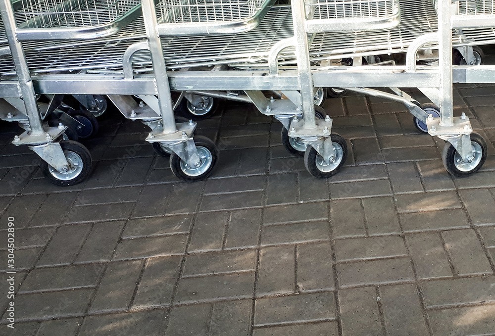 metal carts near the supermarket. wheels metal carts near the supermarket. wheels