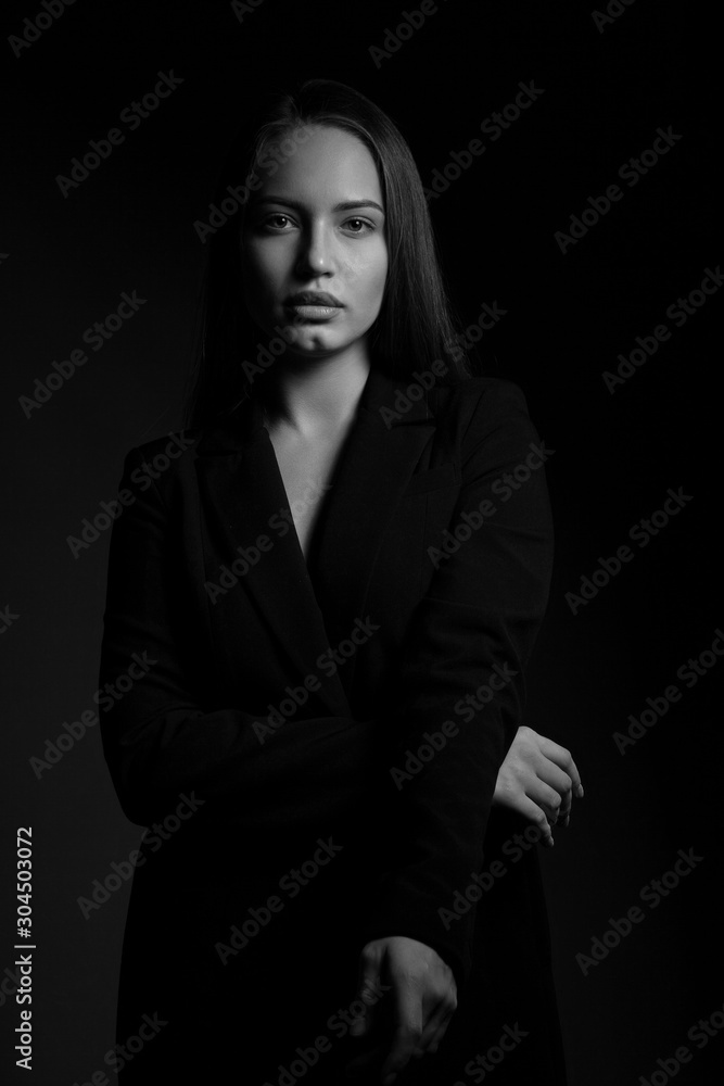 Contrast black and white portrait of a beautiful girl. In a simple Contrast black and white portrait of a beautiful girl. In a simple