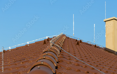 Bild auf Leinwand Tile roof with chimney and lightning protection system installed