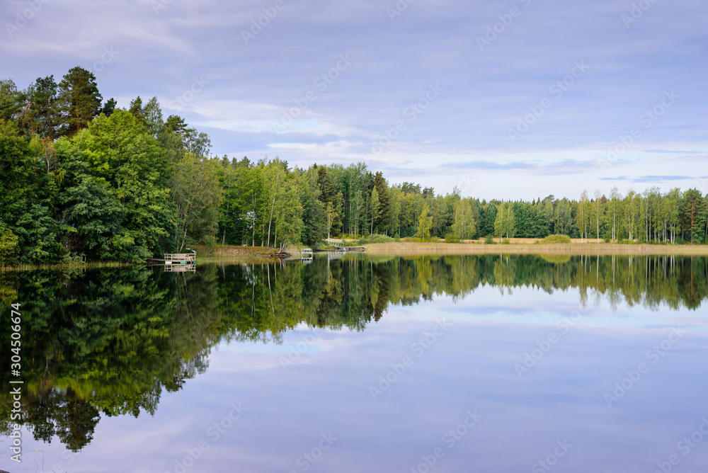 Picturesque lake with forest on the shore in Aurantola village. Typical nature of Finland.