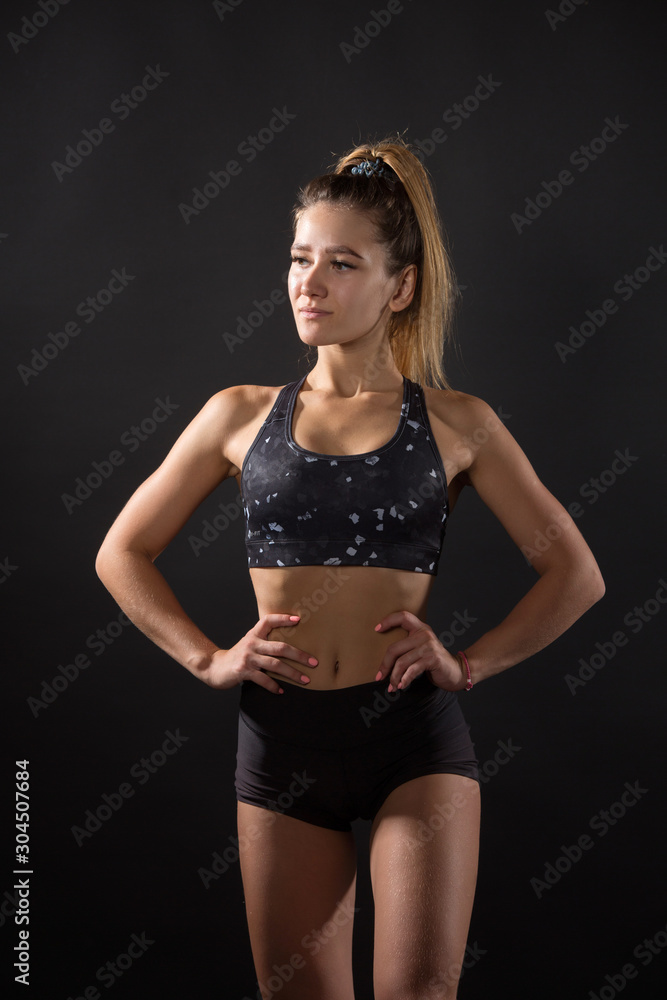 Fototapeta premium beautiful young woman with an athletic figure on a black background