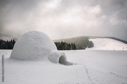 igloo in snowy winter mountains © Volodymyr Shevchuk