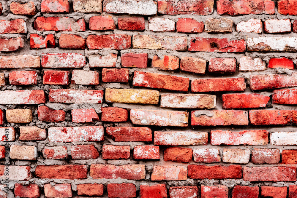 Texture of a brick wall with cracks and scratches which can be used as a background Texture of a brick wall with cracks and scratches which can be used as a background
