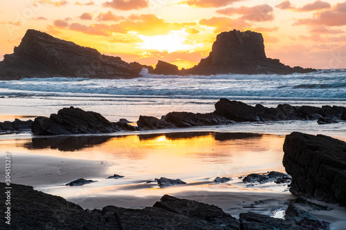 View of Zambujeira do Mar beach at sunset in Costa Vicentina, Portugal