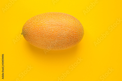 Creative layout made of melon. Flat lay. Food concept. Melon on the yellow background with copy space