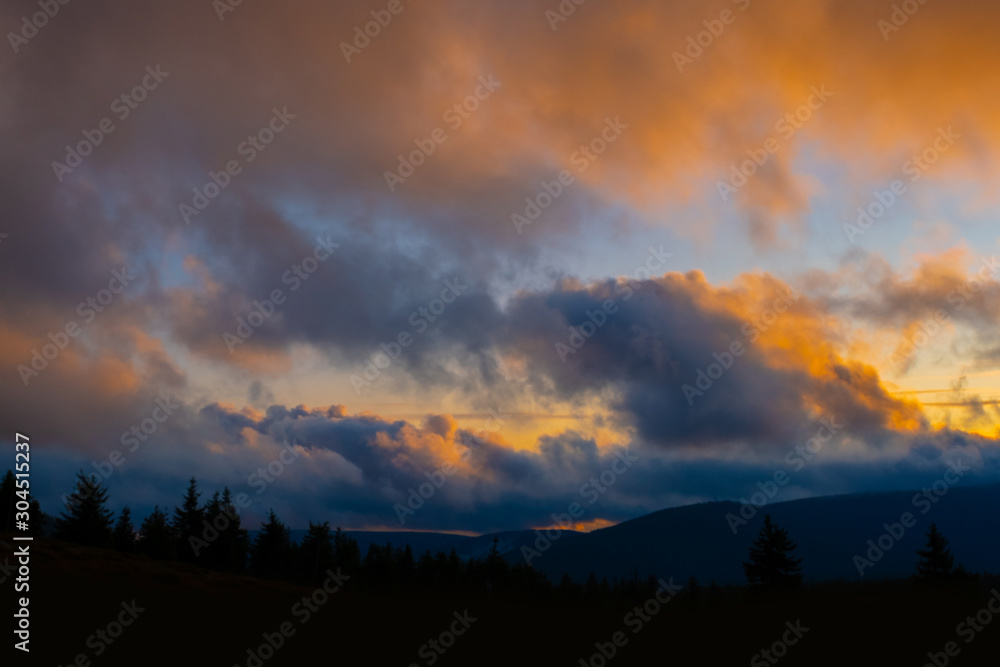 sunset mountain sky blue colorful autumn sun light yellow orange clouds tree smoke fog haze