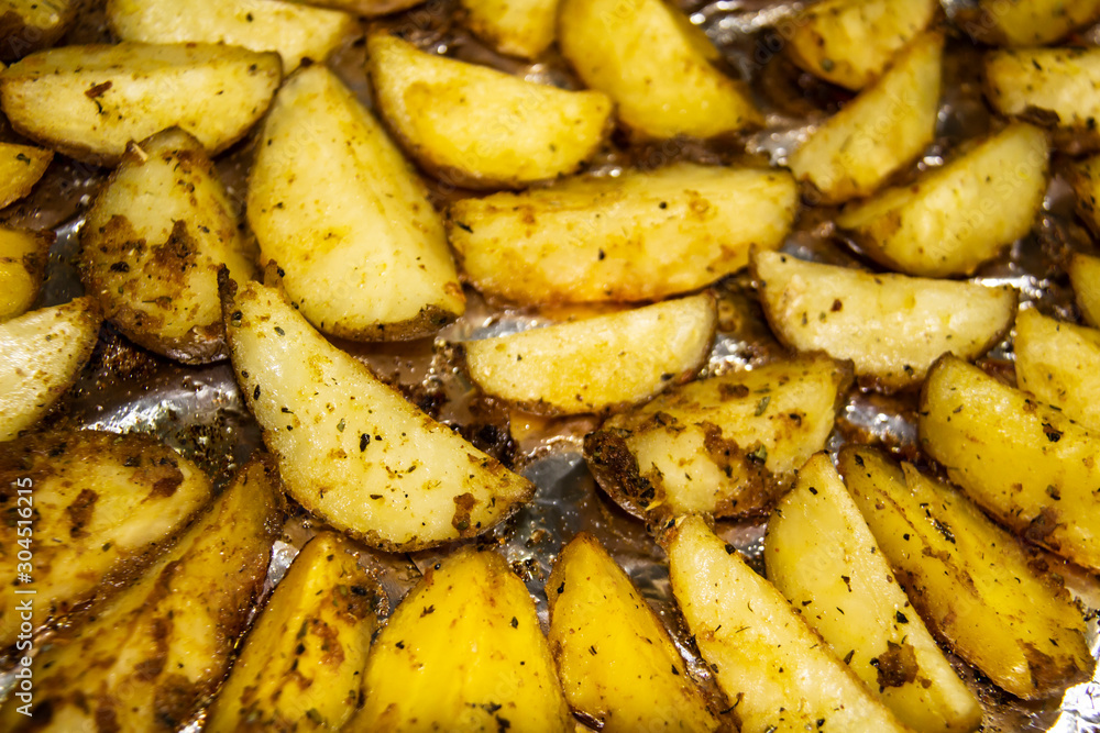 Fried potatoes in the oven.Cooking baked potato. Potatoes peasant. Potatoes with spices. Potatoes on the foil. Fried potatoes in the oven.Cooking baked potato. Potatoes peasant. Potatoes with spices. Potatoes on the foil.