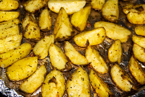 Fried potatoes in the oven.Cooking baked potato. Potatoes peasant. Potatoes with spices. Potatoes on the foil.