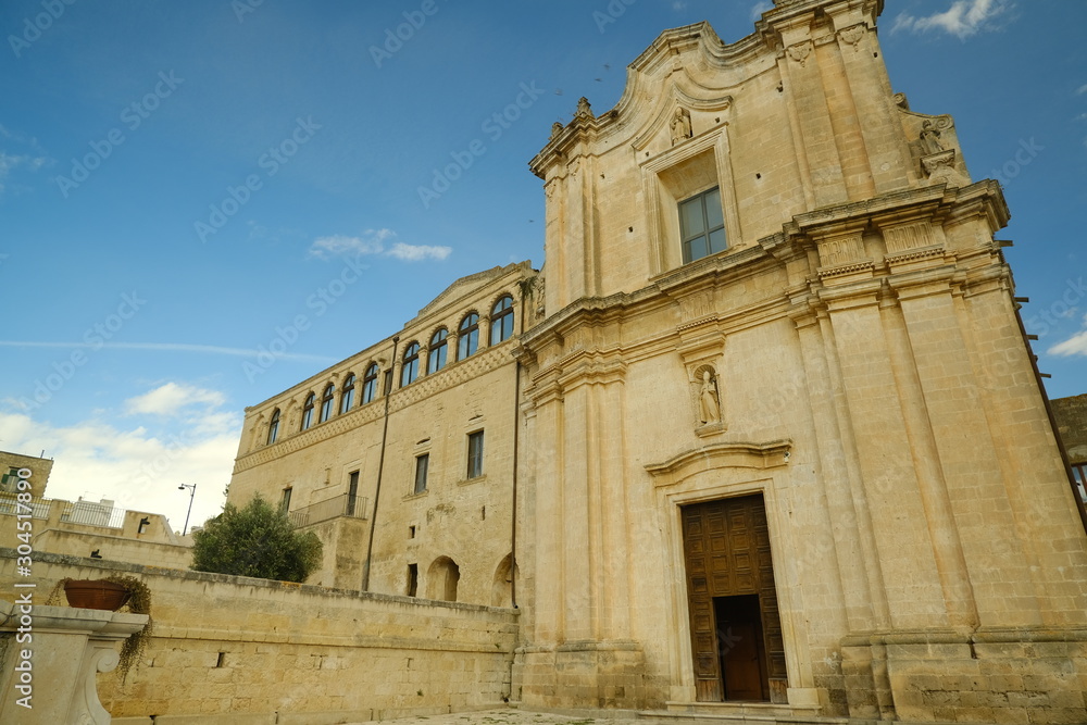 Church and Convent of Sant'Agostino in Matera. Courtyard with olive trees with leaves moving in the wind..