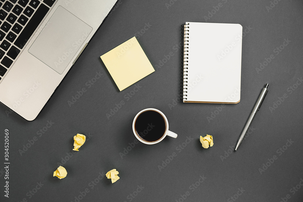 Flat lay financial planning brainstorming messy table top image with office supplies, pen, notepad, laptop, cup of coffee on grey background. Top view, copy space Flat lay financial planning brainstorming messy table top image with office supplies, pen, notepad, laptop, cup of coffee on grey background. Top view, copy space