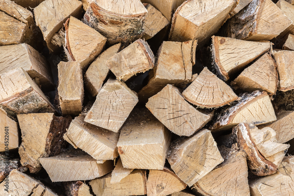 The wooden background closeup, pile of firewood The wooden background closeup, pile of firewood