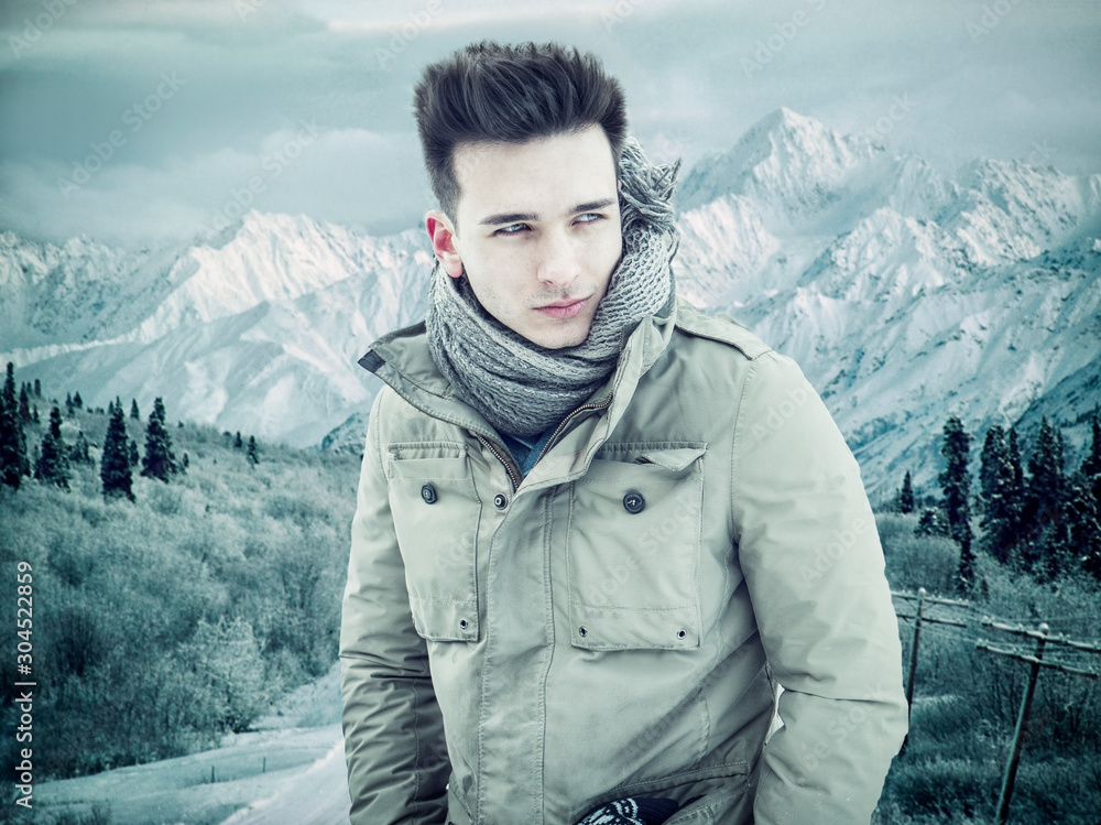 Young handsome man in winter sportswear looking away