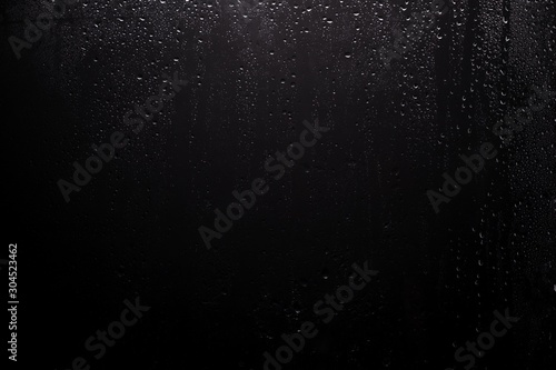 Close up for misted glass with droplets of water draining down